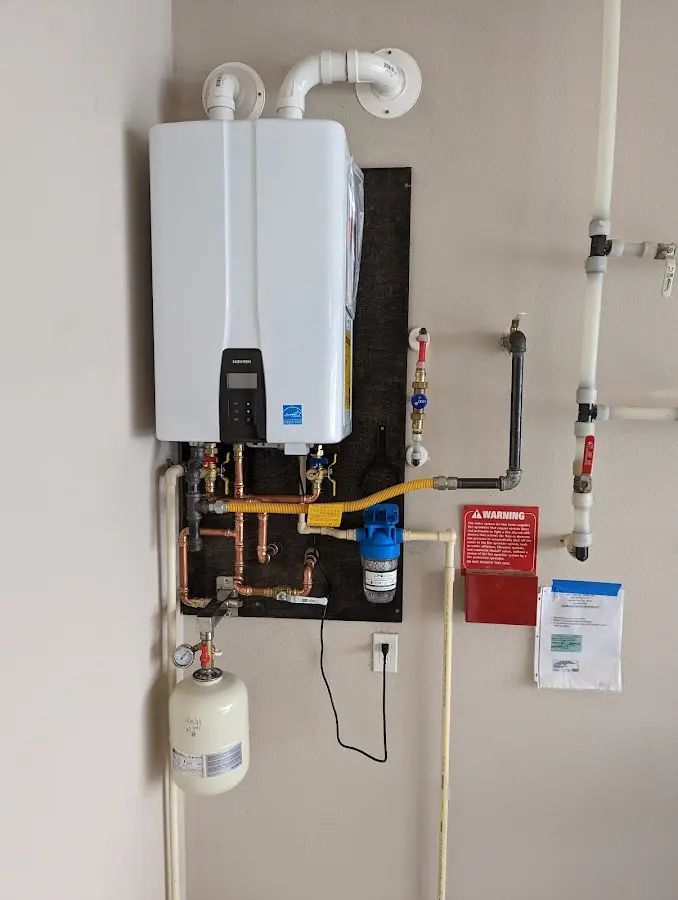 Professional plumber installing copper piping in a Delaware home